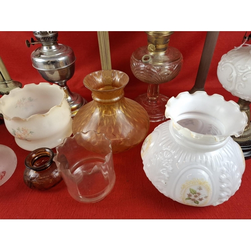 337 - Collection of 6 oil lamps with various glass shades.