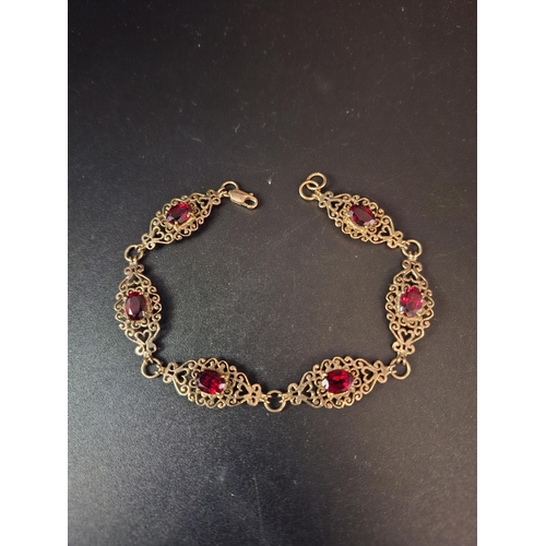 34 - 9ct gold bracelet with garnet inserts 8.1 grams