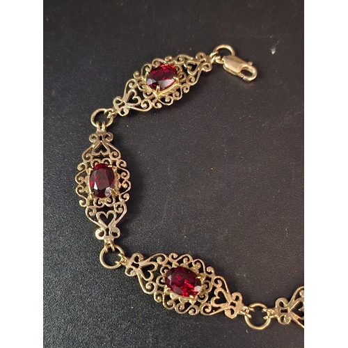 34 - 9ct gold bracelet with garnet inserts 8.1 grams