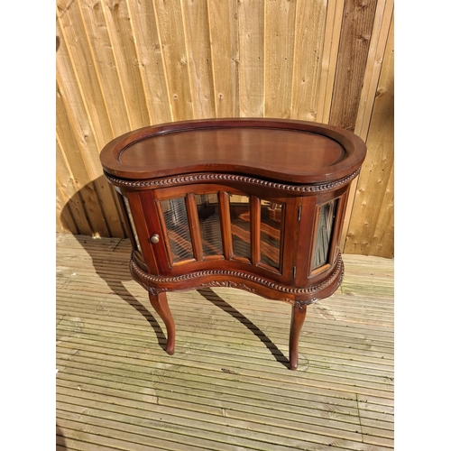 219 - Mahogany kidney bean shaped Drinks cabinet with beveled glass inserts and removable tray.