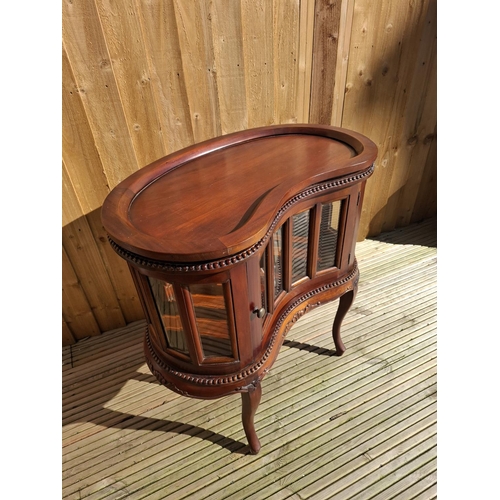 219 - Mahogany kidney bean shaped Drinks cabinet with beveled glass inserts and removable tray.