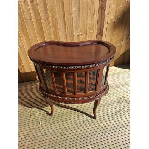 219 - Mahogany kidney bean shaped Drinks cabinet with beveled glass inserts and removable tray.