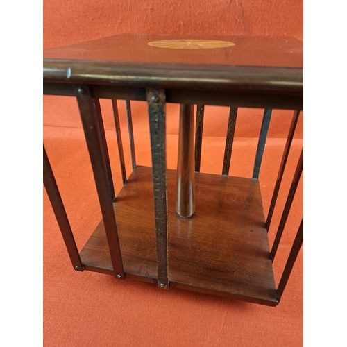 233 - Edwardian revolving bookcase with inlay top. Some repair work to slats. Height 29cm Width 28cm.