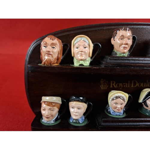 236 - Collection of Royal Doulton Tiny Dickens Oliver Twist Character jugs with stand