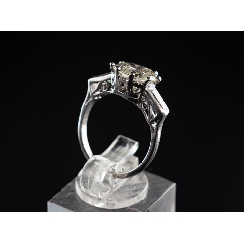 84 - Platinum (950) ring set with one 3.14 carat round brilliant diamond & radiant cut diamonds to each s... 