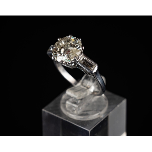 84 - Platinum (950) ring set with one 3.14 carat round brilliant diamond & radiant cut diamonds to each s... 