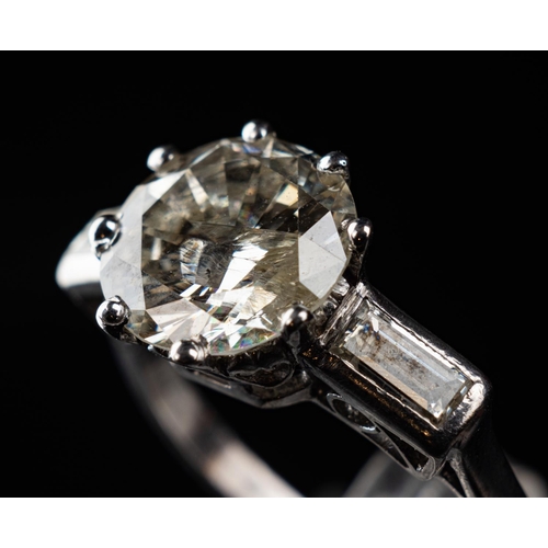 84 - Platinum (950) ring set with one 3.14 carat round brilliant diamond & radiant cut diamonds to each s... 