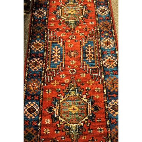 1188 - Length of Vintage Wool Carpet Runner decorated with Geometric shapes on a red ground.