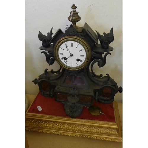 677 - French Cast Metal Mantel Clock with Rouge Marble Panels, Decorated with Birds and Scrolling Shapes.