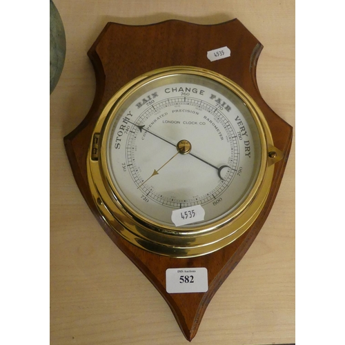 582 - Mounted Circular Brass Compensated Barometer by London Clock co.