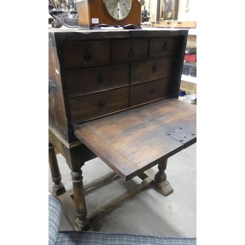 336 - Antique Chest on Stand, the fall front opening to reveal a bank of drawers, the front with metal loc... 