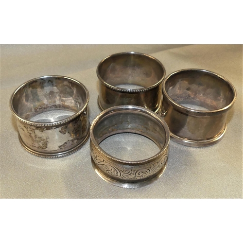 1573 - Four Odd Silver Napkin Rings, weighing approx 3 oz troy.