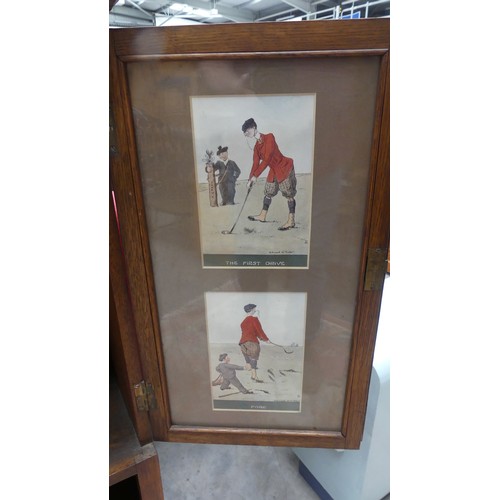 2293 - Edwardian Two Door Oak Cabinet - the door interiors mounted with Golfing prints by Edward G Fuller.