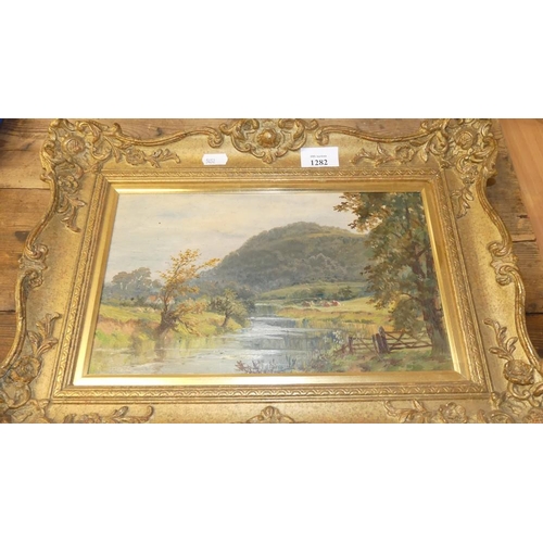 1282 - Framed Oil Painting - River Landscape with Cattle in Distance, unsigned, measuring approx 30 x 18cm.