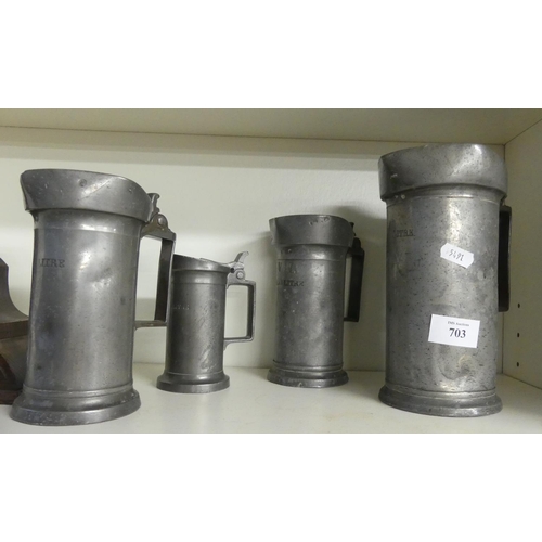 703 - Four Cylindrical Continental Pewter Measures.