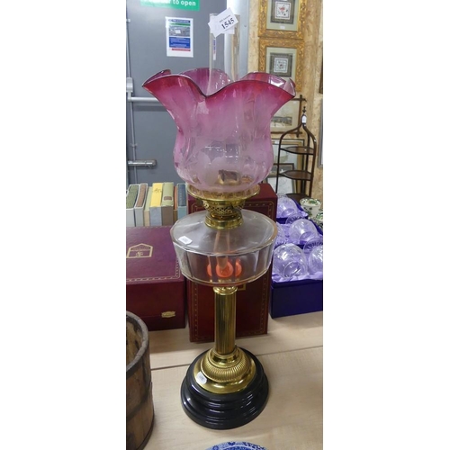 1545 - Victorian Oil Lamp with Brass Column and Cranberry tinted Shade.