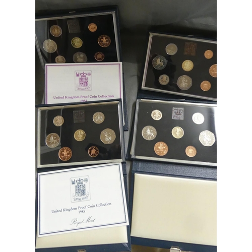 869 - Four Cased Royal Mint Proof Coin Sets - 1p - £1.00, dating 1984 & three from 1985.