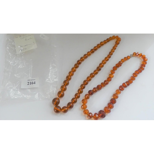 2164 - Two Strings of Amber Coloured Beads.