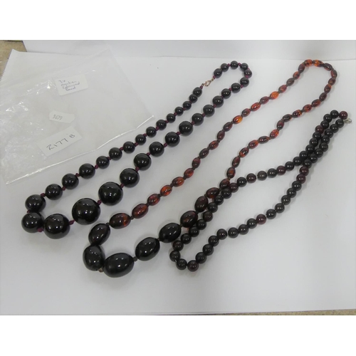 2177B - Three Strings of Amber Coloured Beads.