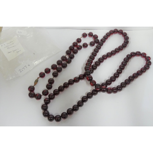 2177N - Two Strings of Amber Coloured Beads.