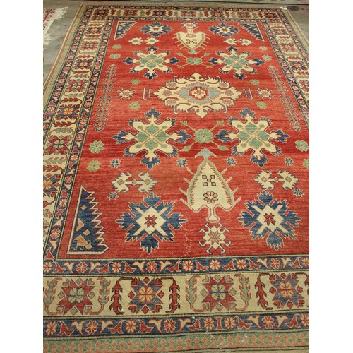 2192 - Large Eastern Wool Rug, Geometric Design on a Red Ground, approx 220 x 325cm.