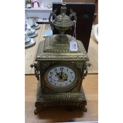 1355 - Ornate French Mantel Clock, Urn shaped finial above a enamel chapter ring, Arabic numerals, flanked ... 