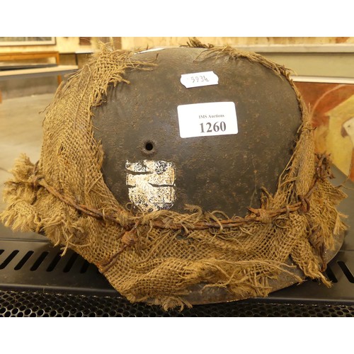 1260 - German WWII Helmet - Hessian Sacking Camouflage held in-place with a strand of barbed wire.