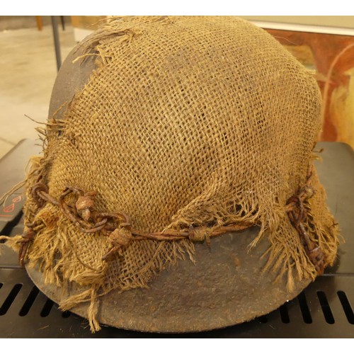 1260 - German WWII Helmet - Hessian Sacking Camouflage held in-place with a strand of barbed wire.