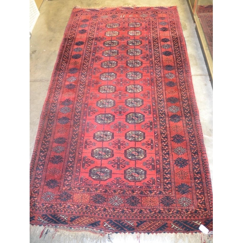 2528 - Red Ground Bukhara Wool Rug, approx 194 x 103cm.