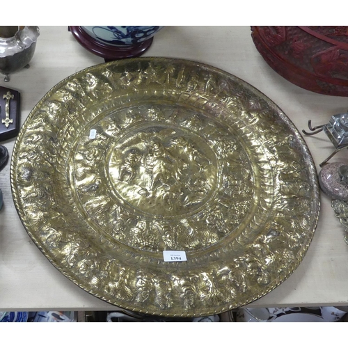 1394 - Large Indian Embossed Brass Charger, approx 58cm in diameter.