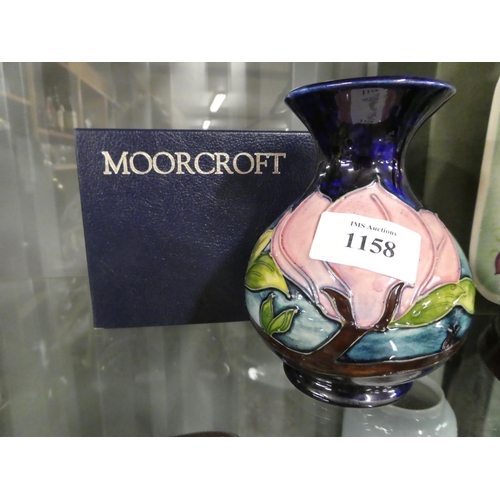 1158 - Moorcroft Pottery Vase - Magnolia on Dark Blue Ground, approx 13cm tall.