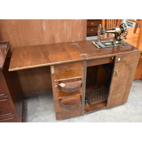 3137 - Singer Sewing Machine In Oak Cabinet