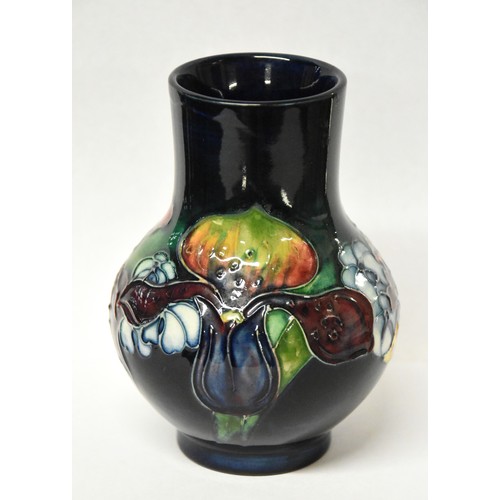 1238 - Moorcroft Pottery Vase - Iris on a dark blue ground, approx 12cm tall.