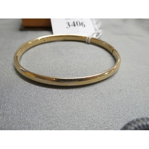 3406 - 9ct Gold Bangle  6.22gms - spring closure (no catch as such), oval approx 6.5cm x 6cm.