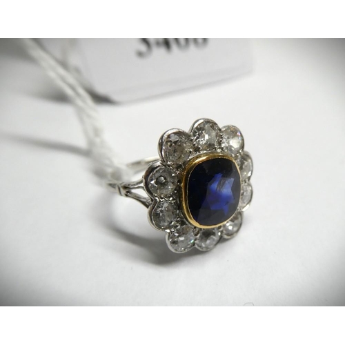 3408 - Platinum Dress Ring with Central Sapphire Surrounded with 10 Diamonds, size UK L, weighs approx 5.2g