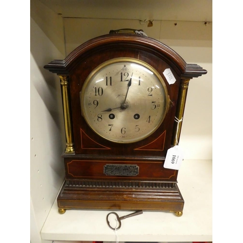 1069 - Antique Mahogany Brass Mounted Mantel Clock, with winding Key.