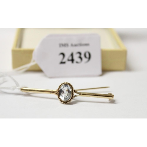 2439 - 9ct Gold Bar Brooch Mounted with Blue Topaz.