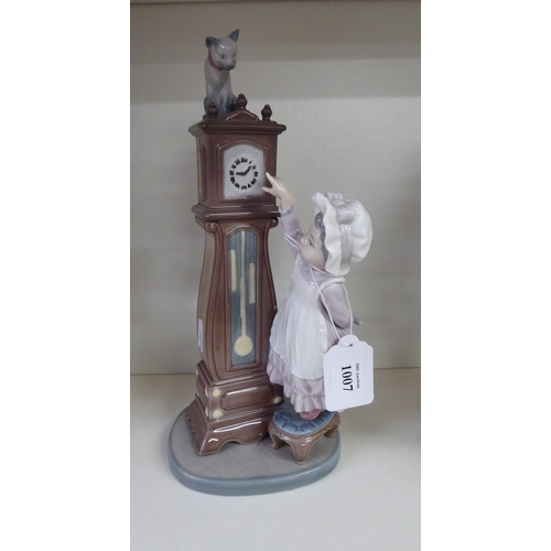 1007 - Lladro Porcelain Figurine - Young Girl by Longcase Clock, approx 28cm tall.