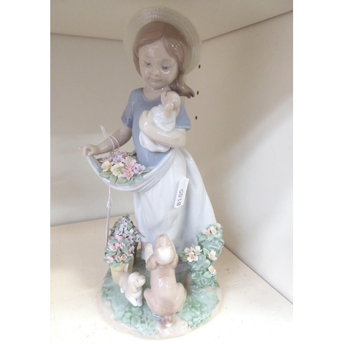 1014 - Lladro Porcelain Figurine - 6907 Girl with Puppy, approx 23cm tall.