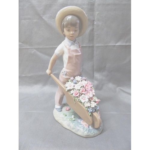 1046 - Lladro Porcelain Figurine - 1283 Young Boy with Flower Filled Wheelbarrow, approx 25cm tall.