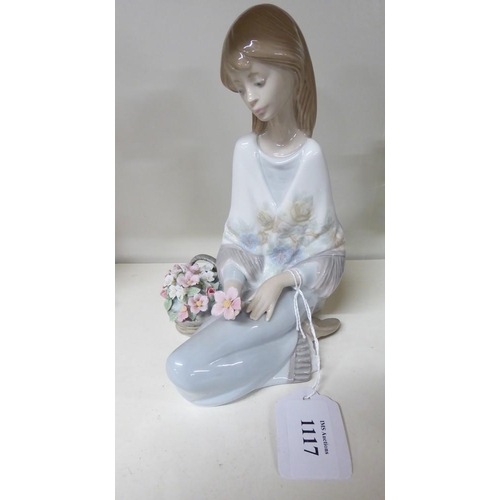 1117 - Lladro Porcelain Figurine - Girl Seated with Flowers, approx 19cm tall.