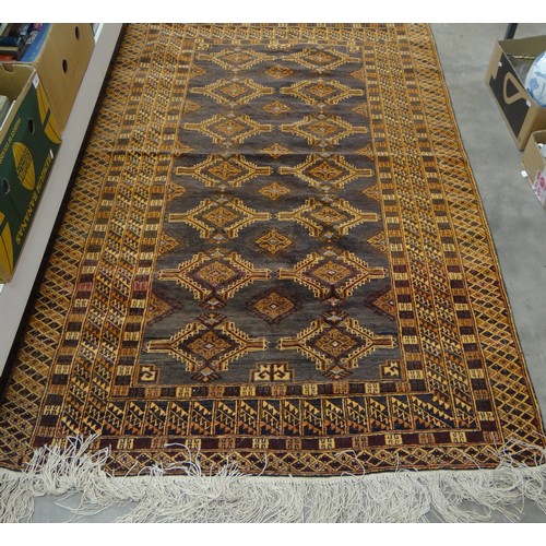 2457 - Eastern Wool Rug, orange ground, central guls roup within a deep border, approx 196 x 127cm.