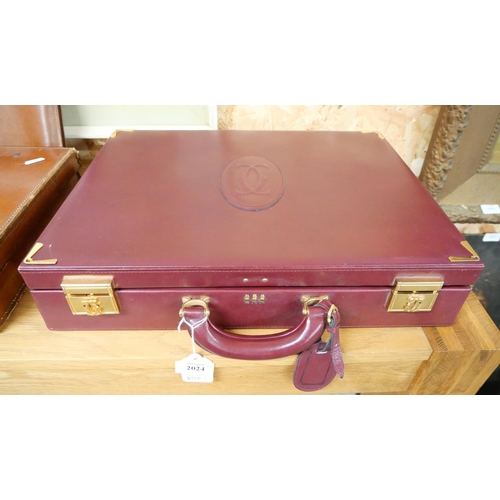 2024 - Burgundy Calfskin Briefcase with gold finished metal parts. Exterior: embossed double C logo, Interi... 