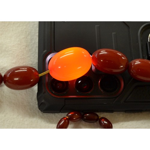 2410 - String of Graduated Cherry Amber Beads, approx 62g, 41cm long, largest bead measuring 3cm across.