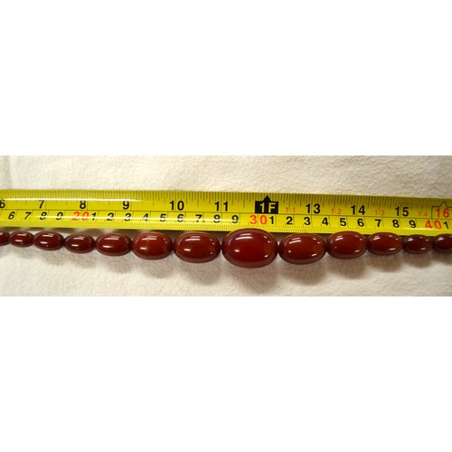 2410 - String of Graduated Cherry Amber Beads, approx 62g, 41cm long, largest bead measuring 3cm across.