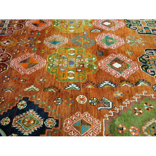 2532 - Large Eastern Wool Rug Orange to Red Ground with Colourful Motifs 187cm x 266cm.
PLEASE NOTE THAT DU... 