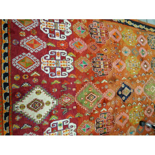 2532 - Large Eastern Wool Rug Orange to Red Ground with Colourful Motifs 187cm x 266cm.
PLEASE NOTE THAT DU... 