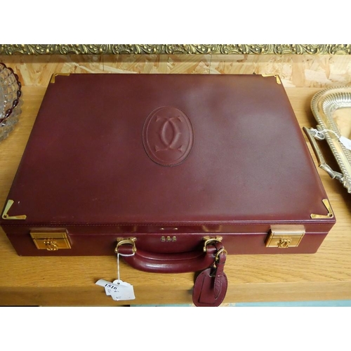 1516 - Cartier Burgundy Calfskin Briefcase with gold finished metal parts. Exterior: embossed double C logo... 