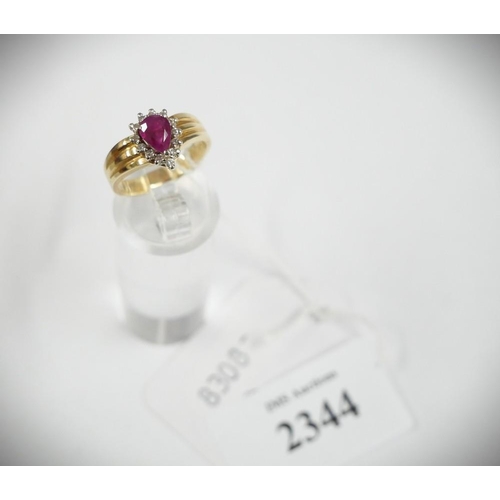 2344 - 14K Cluster Set Ring, single Pendeloque Ruby within a single frame of thirteen round brilliant cut D... 