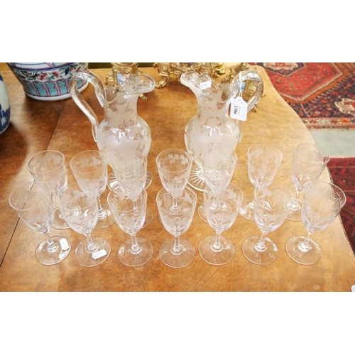 1386 - Pair of Antique Engraved Glass Jugs and 14 Vine Etched Wine Glasses.